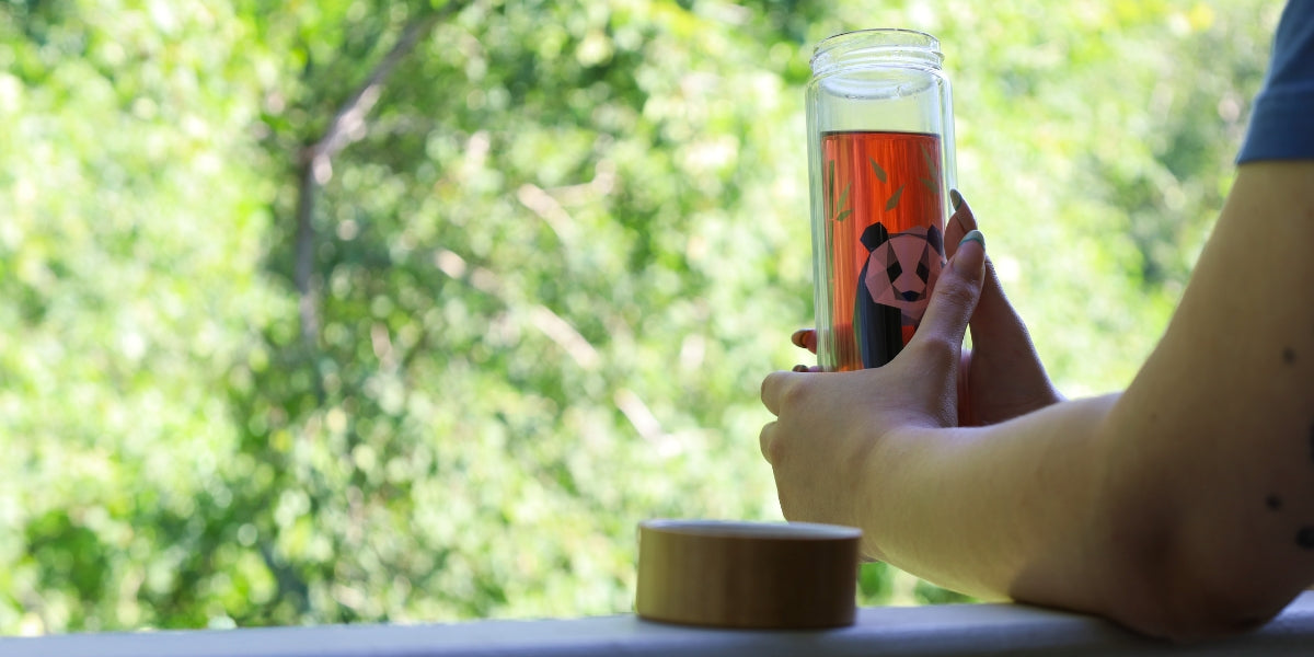 Holding a glass tea tumbler outside