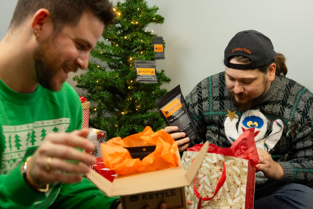 Recipient opening  a gift that's a box of whistling kettle teas