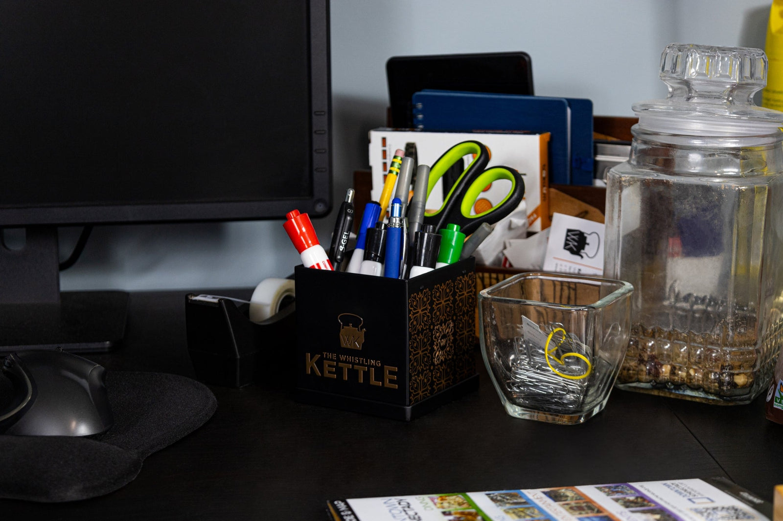 school supplies in a Whistling Kettle tea tin