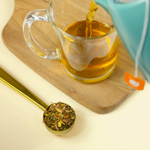 Belly Buddy tea being poured into glass.