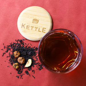 Glass of brewed Cherry Fig next to Cherry Fig loose leaf tea.