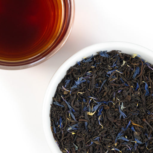 Top mound picture of The Whistling Kettle Earl Grey black tea with bergamot and cornflowers, loose leaf and brewed.