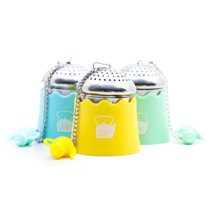 The Whistling Kettle "The Egg" Stainless Steel Tea Ball Infuser with Drip Tray in green, blue, and yellow.