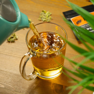 Nordic Tea Pot of brewed Greek Mountain tea being poured into glass.