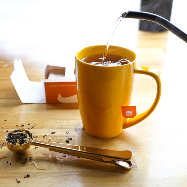 Kettle pouring water into cup with Loose Leaf Paper Tea Bags inside