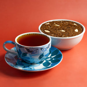 Cup & Saucer filled with brewed Marzipan next to bowl of Marzipan loose leaf tea.