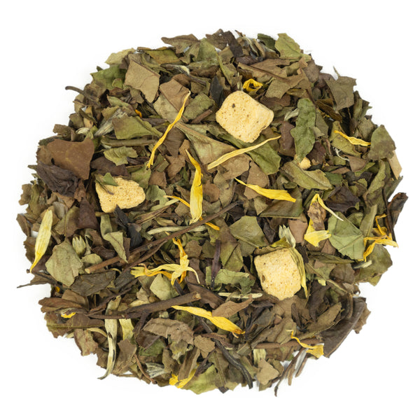 Top mound picture of The Whistling Kettle Peach White tea with flower petals and dried fruit.