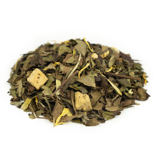 Side mound picture of The Whistling Kettle Peach White tea with flower petals and dried fruit.