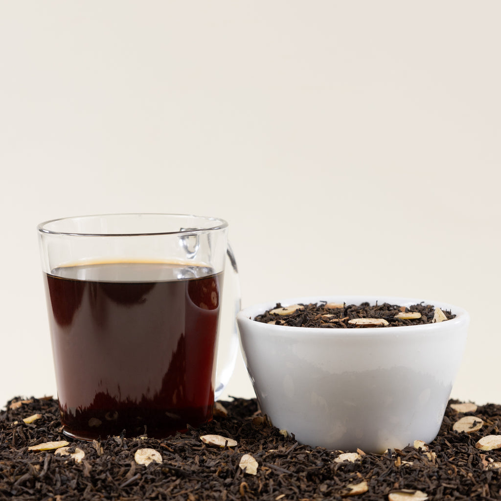 Glass of Scottish Caramel tea next to Scottish Caramel tea leaves.