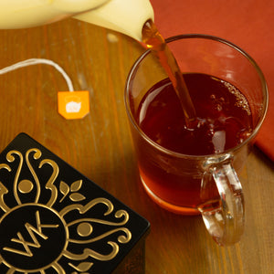 Brewed Vanilla Rooibos tea being poured into glass.