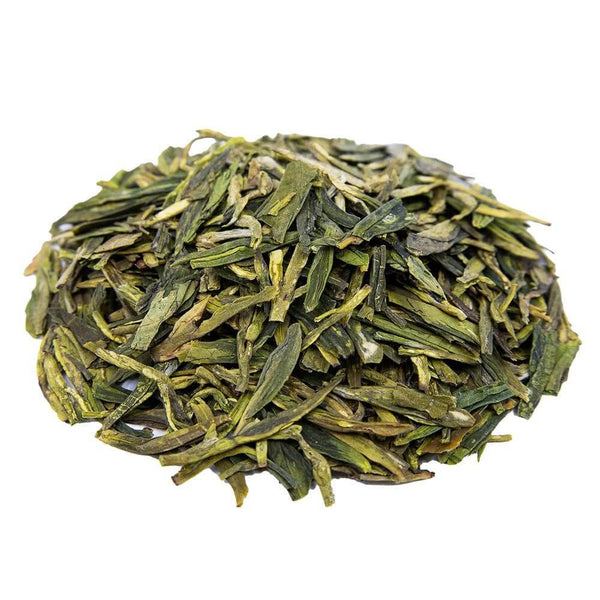 Side mound picture of The Whistling Kettle Dragonwell Lung Ching green tea with long vibrant leaves.